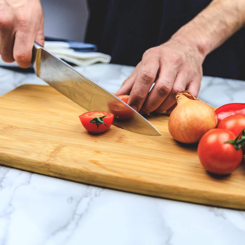 Bamboo cutting board - cutting tomato