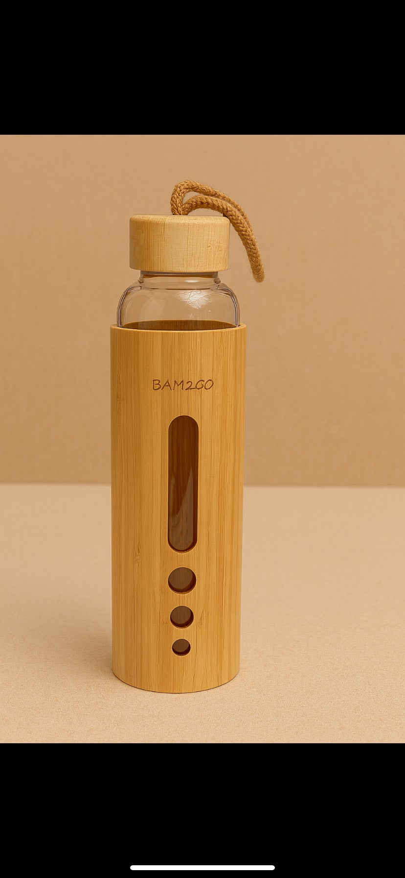 Bamboo water bottle with a clear glass body and wooden cap on a beige background